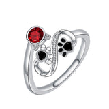Verstellbarer Ring mit schwarzem Pfotenabdruck und rotem Edelstein
