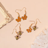 Kristallohrringe in Gold mit Bienen- und Honigwaben-Motiv