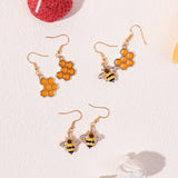 Kristallohrringe in Gold mit Bienen- und Honigwaben-Motiv